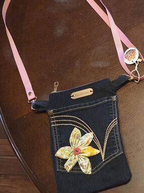 Twisted Sisters Denim Crossbody with Pink Strap and Floral Accent